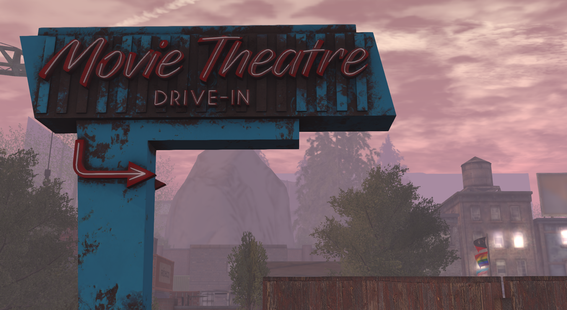 Old fashioned neon road sign reading "Movie Theatre Drive-in"